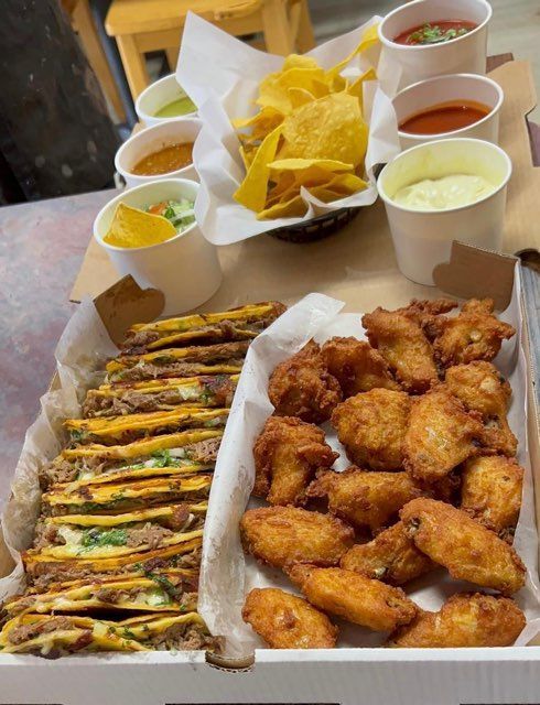 Party tray with chicken and sides from So Sabroso