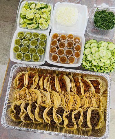 Party tray of tacos with fresh sides from So Sabroso